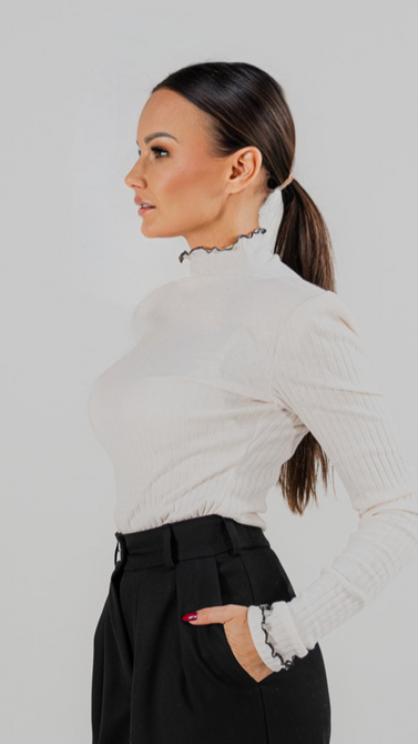 Blouse made of openwork knit fabric in ecru color and black trim