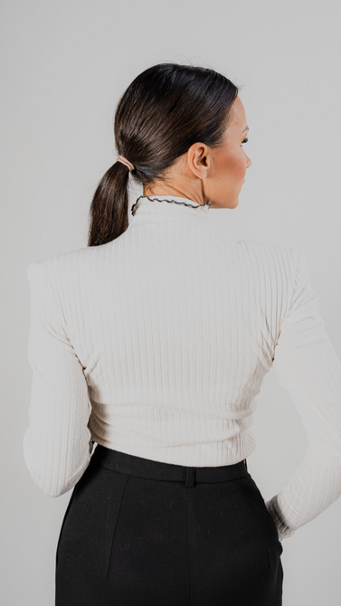 Blouse made of openwork knit fabric in ecru color and black trim