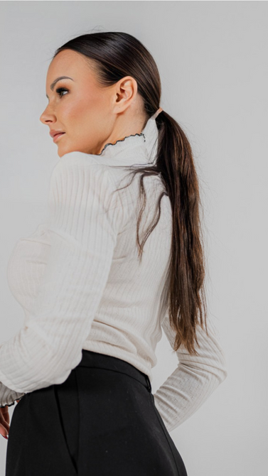 Blouse made of openwork knit fabric in ecru color and black trim